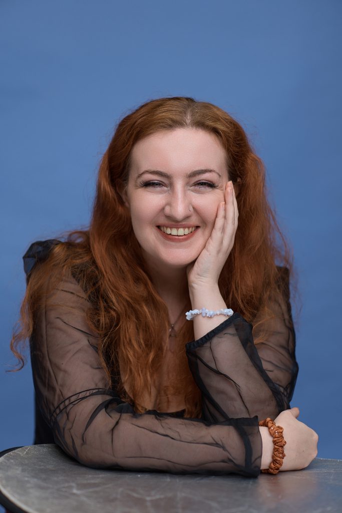 Corporate portrait of a professional photographed on a blue backdrop