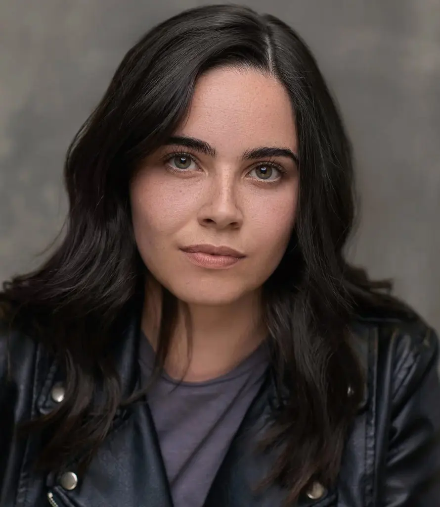 Actress in a black leather jacket photographed against a dark studio backdrop for a Liverpool casting headshot
