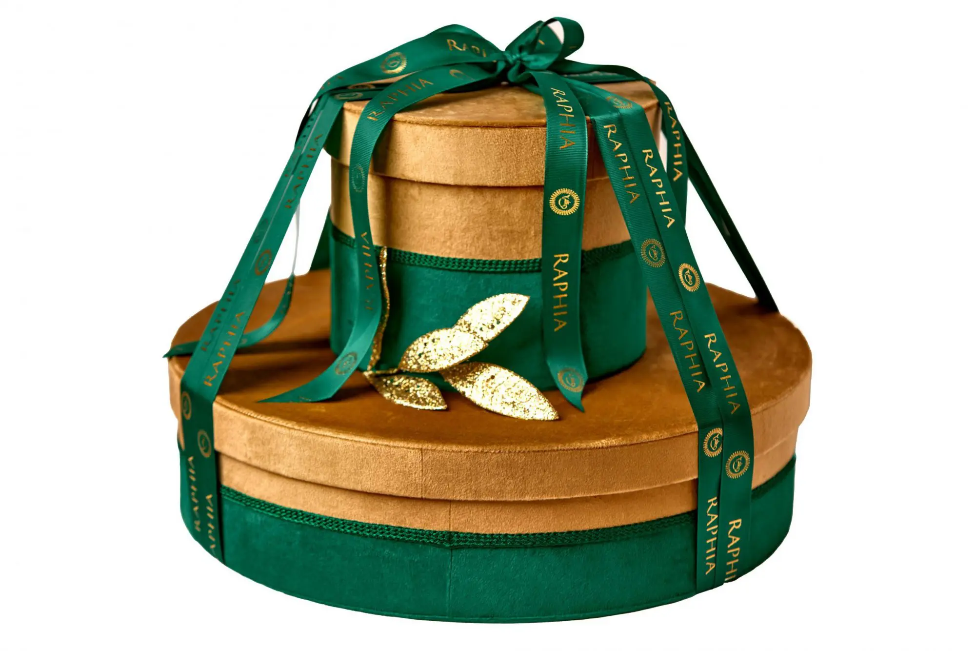 Stacked gold and green velvet Raphia gift boxes tied with branded ribbon, ecommerce product photography in Liverpool