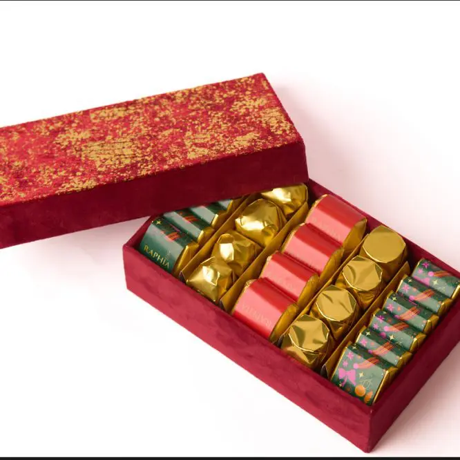 Red luxury chocolate gift box open to show individually wrapped chocolates, ecommerce product photography in Liverpool by Captured By Luke Media