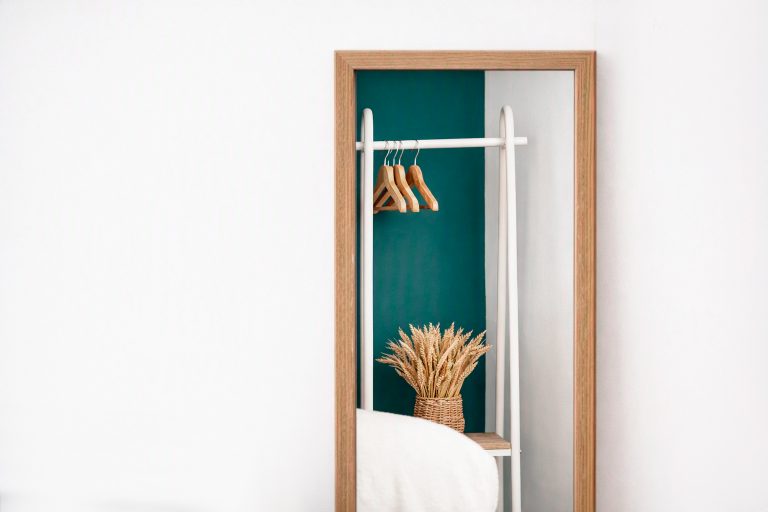 Styled bedroom corner with mirror and clothes rail, property photography Liverpool