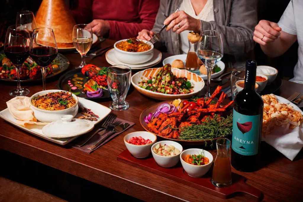 Shared restaurant table of dishes and wine, marketing photography in Liverpool by Captured By Luke Media