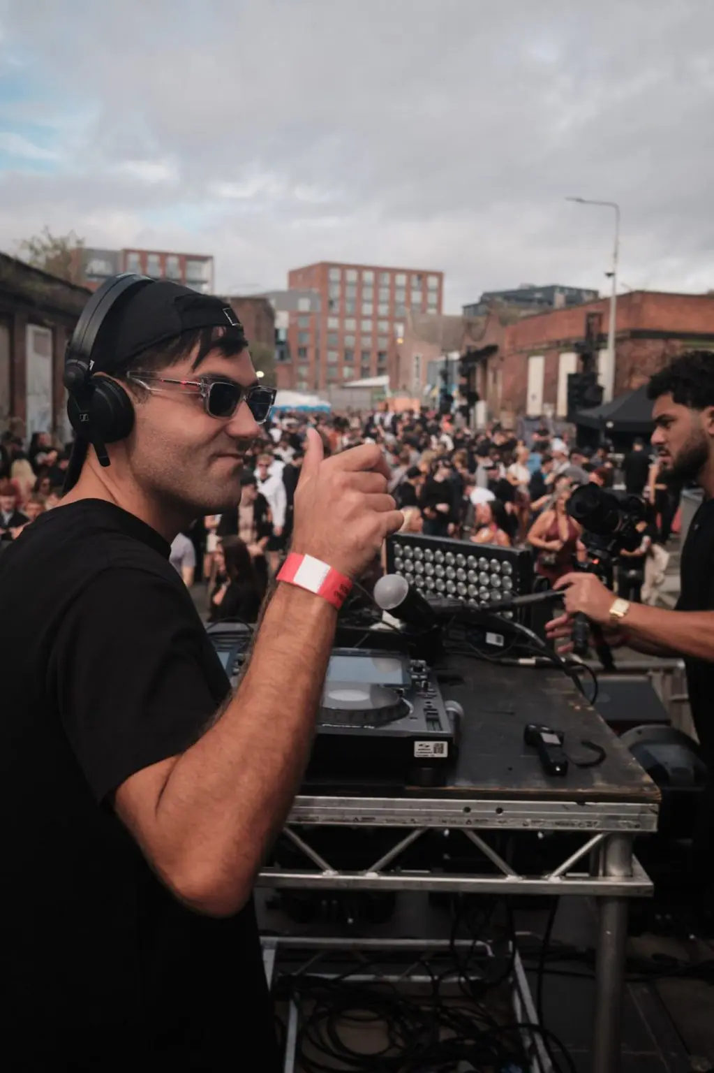 DJ Huzey playing to a packed crowd at an open air event in the Baltic Triangle, Liverpool