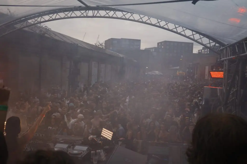 Wide shot of the crowd at an open air rave in Liverpool