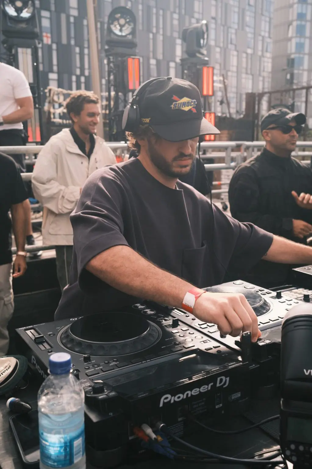 DJ in the booth surrounded by the crowd at an open air music event in Liverpool