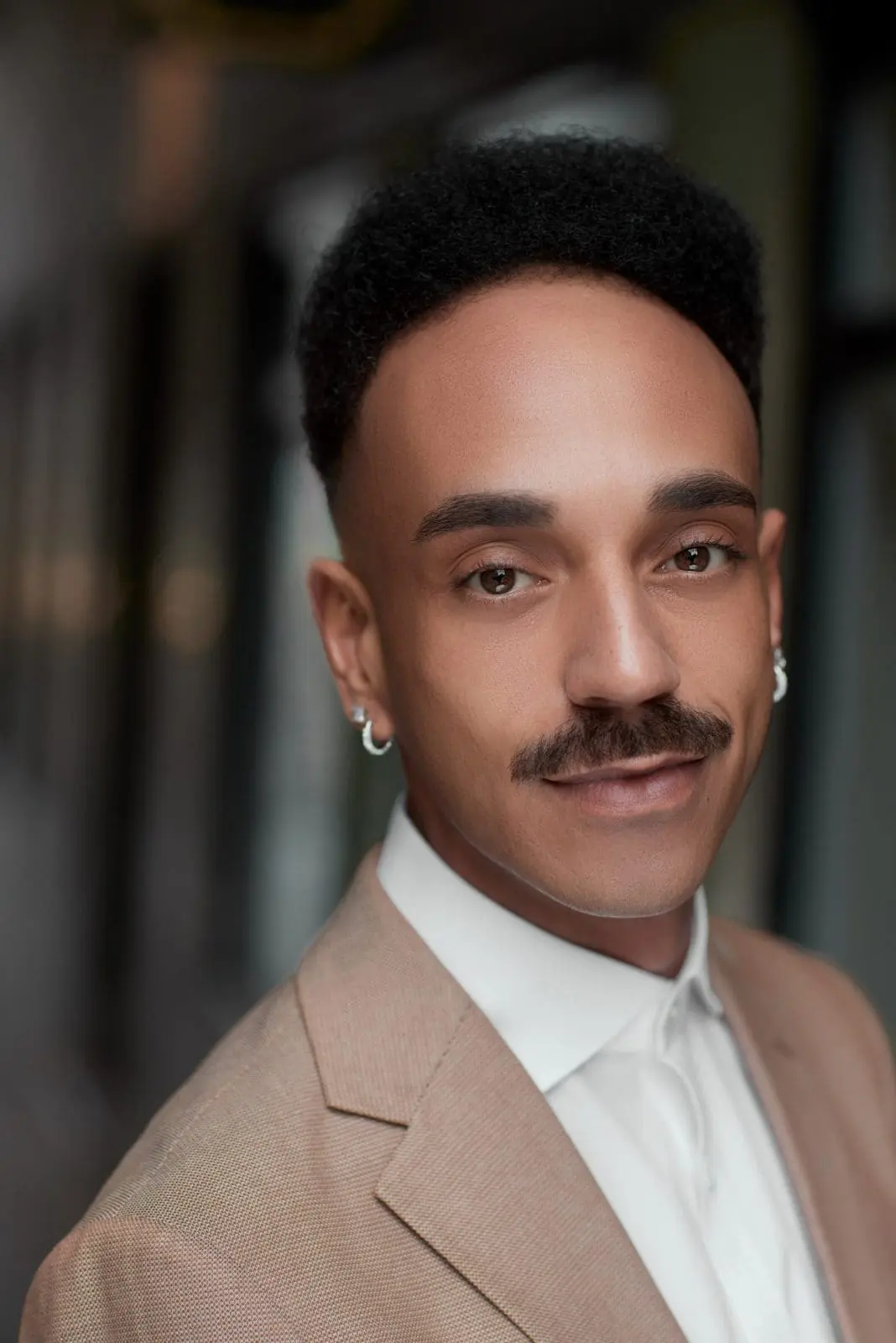 Corporate headshot of a man in a beige suit and white shirt, photographed in Liverpool by Captured By Luke Media