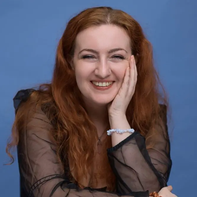 Corporate headshot of a woman on a blue background, Liverpool business portrait by Captured By Luke Media
