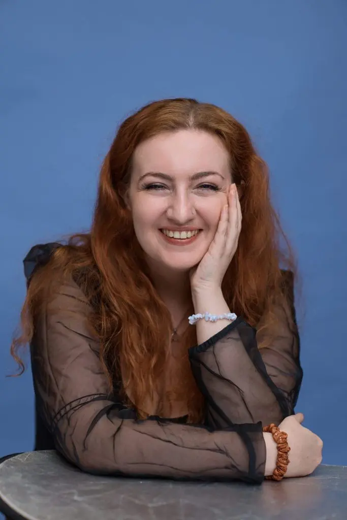 Corporate headshot of a woman on a blue background, Liverpool business portrait by Captured By Luke Media