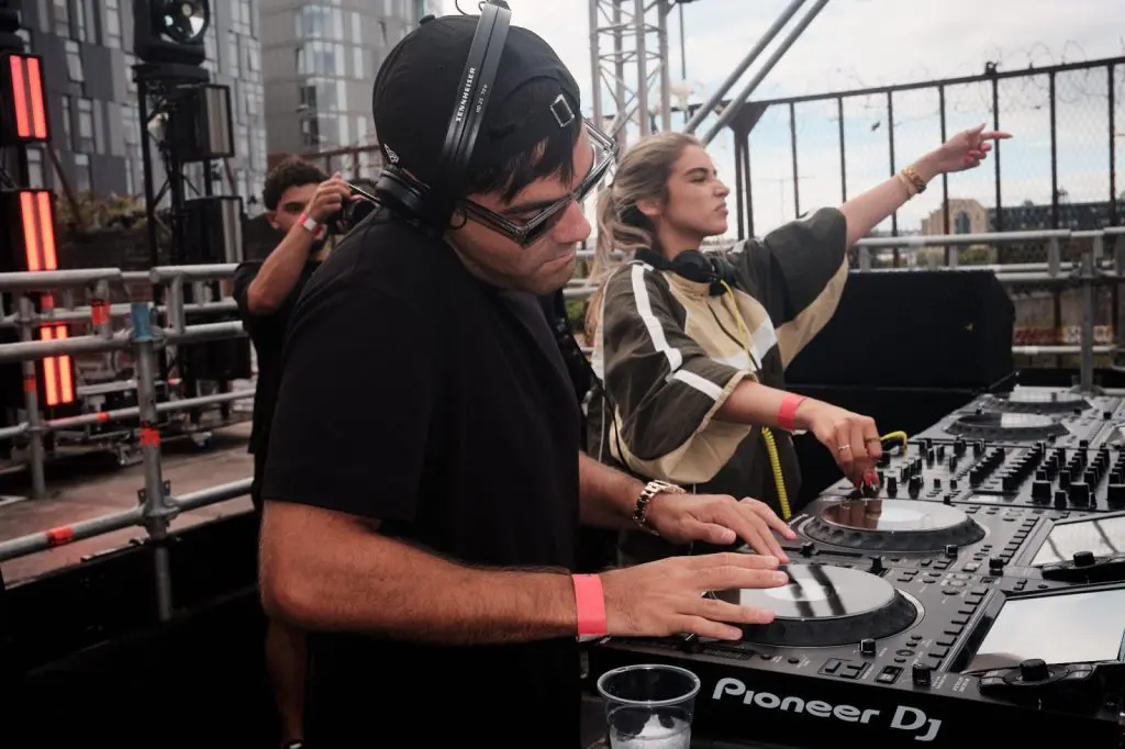 DJ Huzey on the decks with the crowd behind him at COCO Open Air, Liverpool