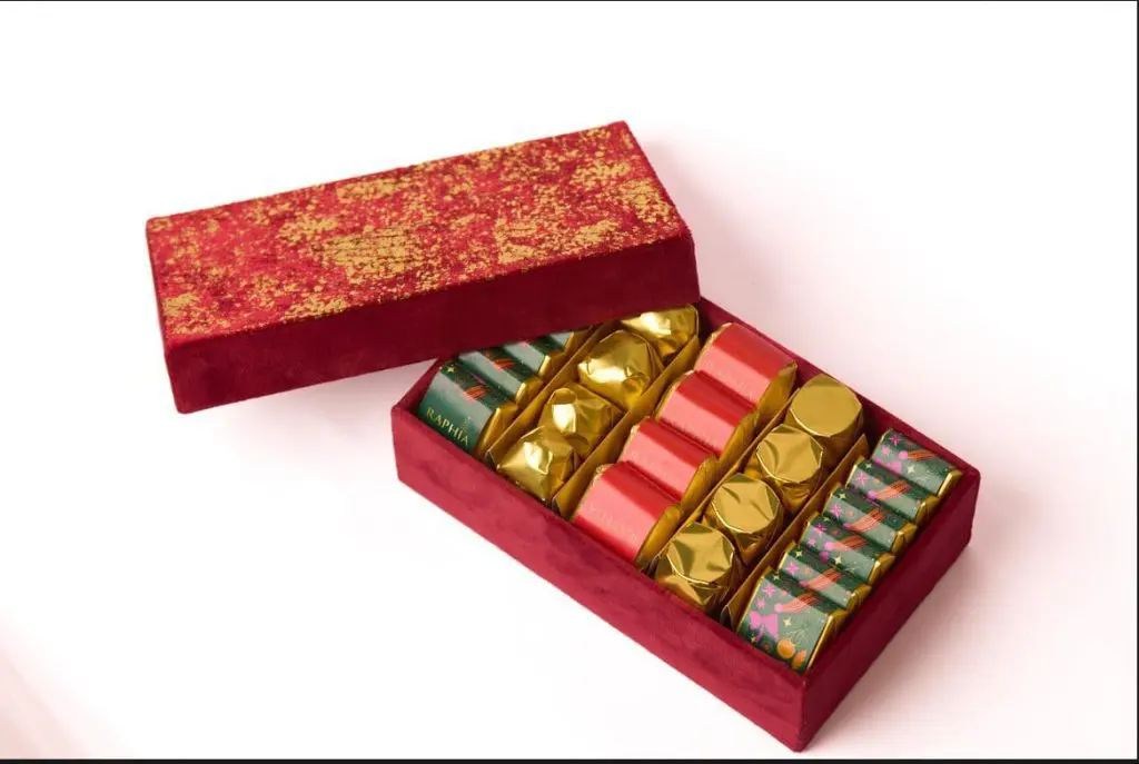 Red luxury chocolate gift box open to show individually wrapped chocolates, ecommerce product photography in Liverpool by Captured By Luke Media