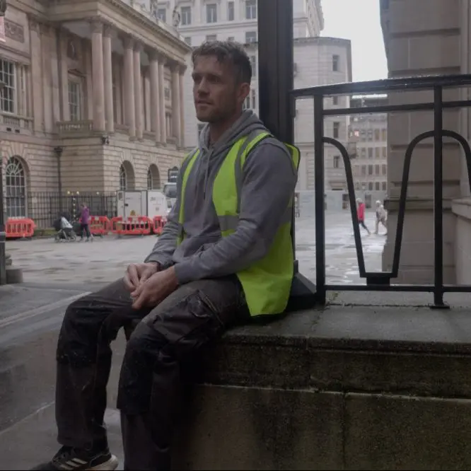 A worker taking a break outside a Liverpool workplace, filmed for a recruitment video