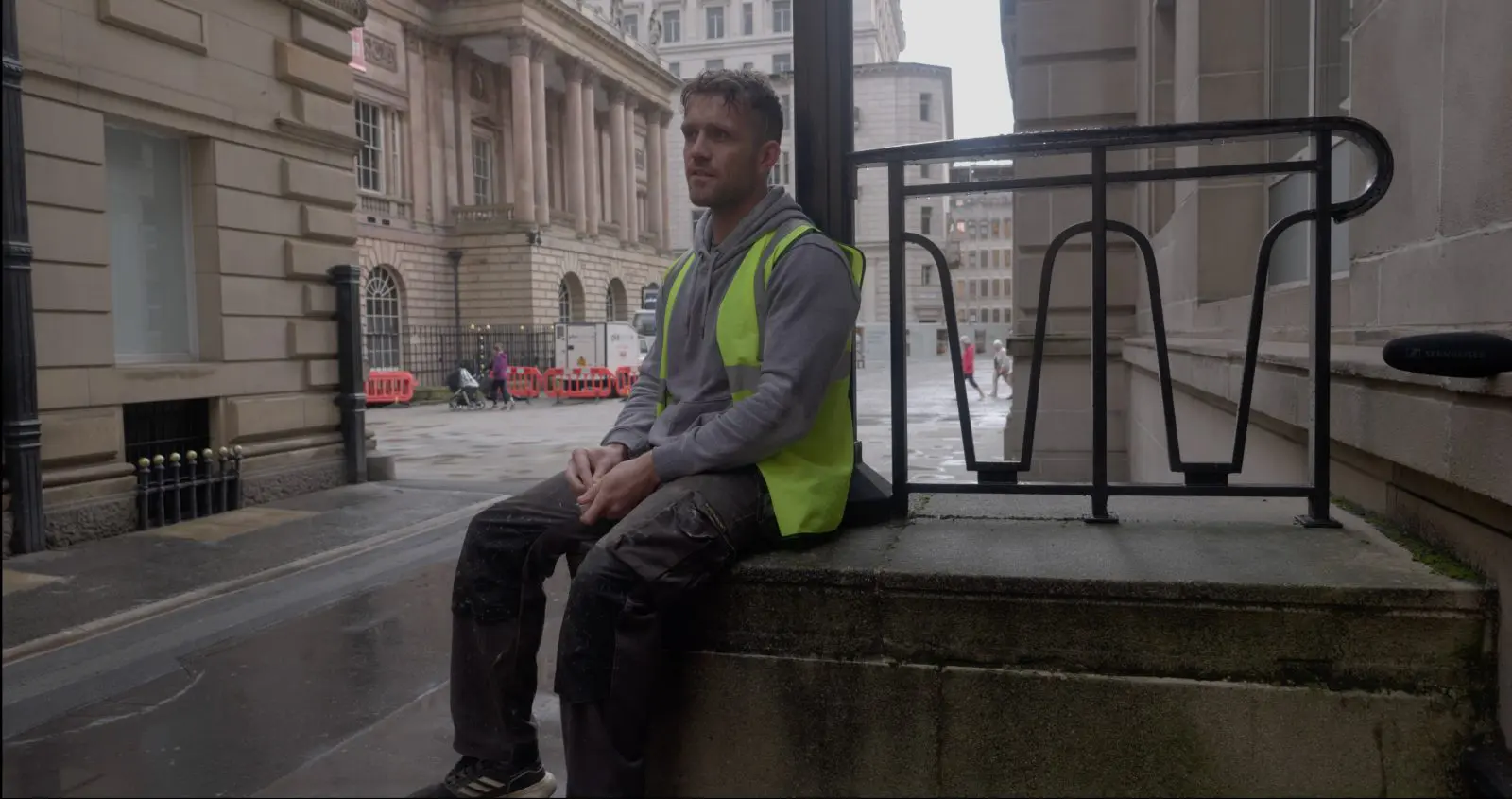 A worker taking a break outside a Liverpool workplace, filmed for a recruitment video