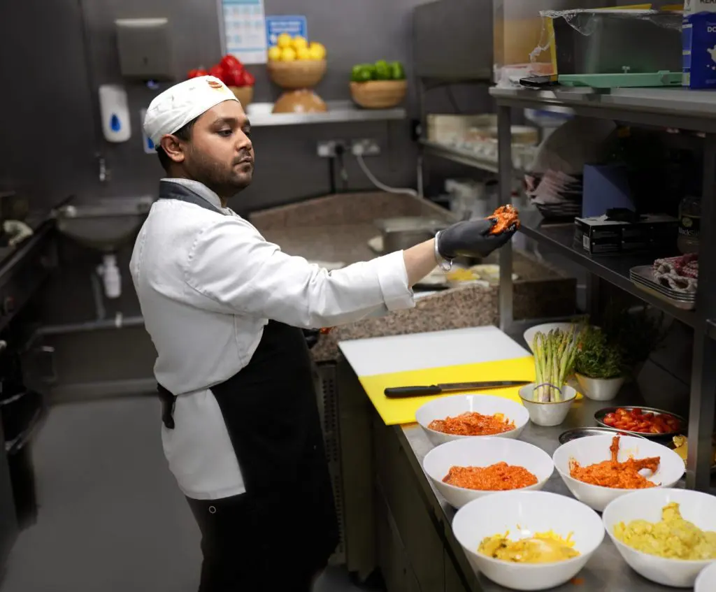 A chef at work in a Liverpool kitchen during service, filmed for careers content