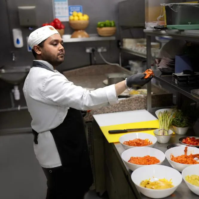 A chef at work in a Liverpool kitchen during service, filmed for careers content