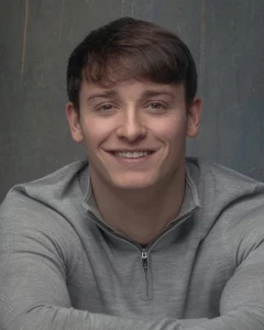 Young male actor smiling in a studio headshot taken in Liverpool