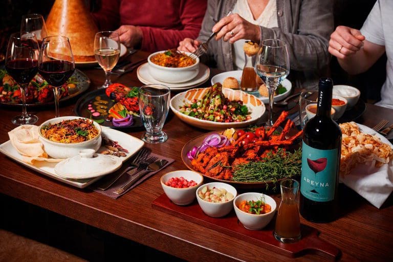 Restaurant marketing photography of a shared table of dishes and wine in Liverpool by Captured By Luke Media