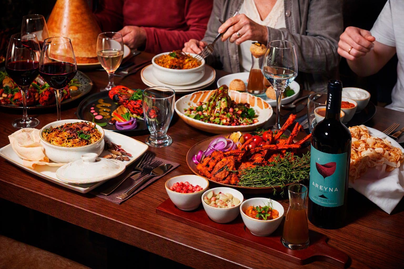 Shared restaurant table of dishes and wine, marketing photography in Liverpool by Captured By Luke Media