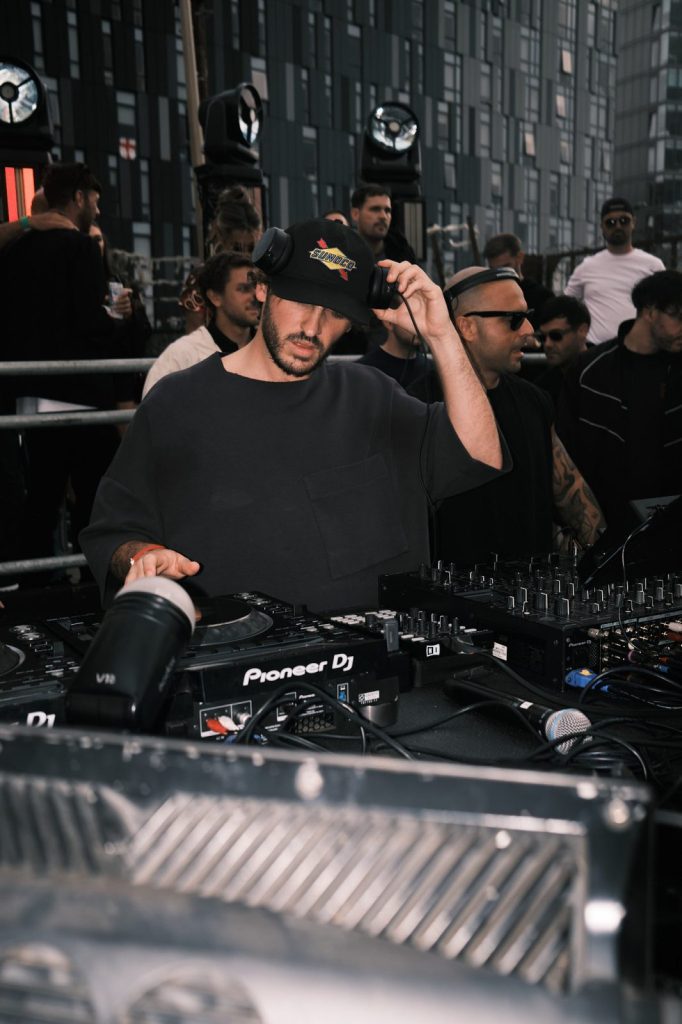 DJ working the Pioneer decks at an open air event in the Baltic Triangle, Liverpool