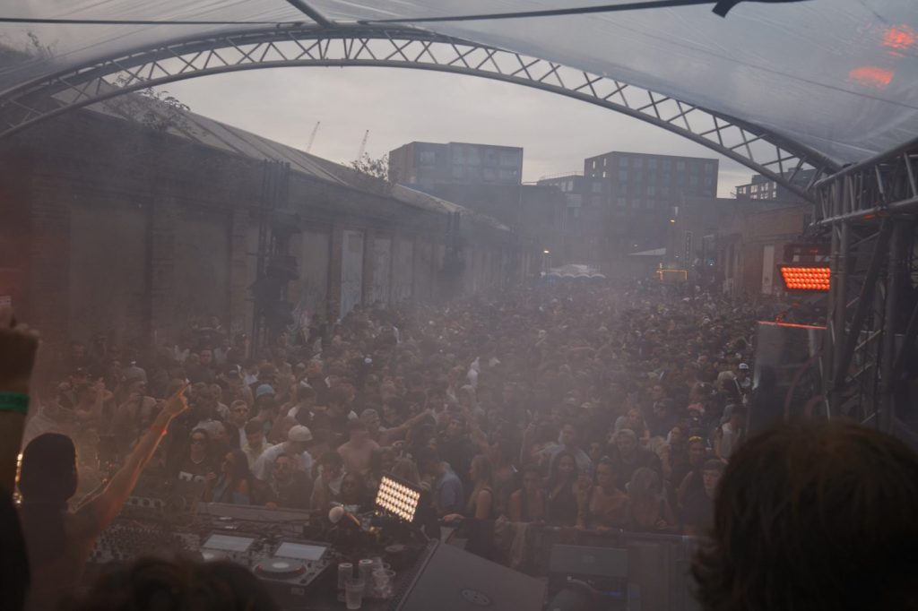 Wide shot of the crowd at an open air rave in Liverpool