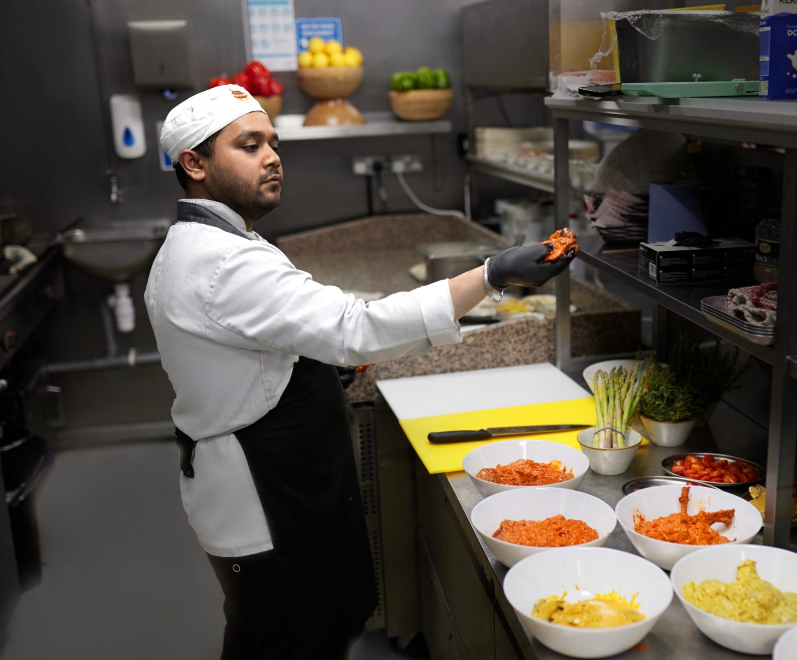 A chef at work in a Liverpool kitchen during service, filmed for careers content